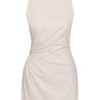 This dress is a sleeveless, natural beige mini-dress made from a lightweight fabric. It features a gathered, ruched detail at the side with an open crochet accent, adding a unique and stylish texture. The bottom hem has a delicate fringe trim, giving the dress a relaxed, bohemian vibe. The simple round neckline and fitted silhouette highlight its minimalistic yet elegant design, perfect for casual or semi-formal summer wear.