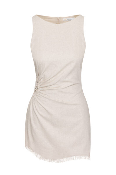 This dress is a sleeveless, natural beige mini-dress made from a lightweight fabric. It features a gathered, ruched detail at the side with an open crochet accent, adding a unique and stylish texture. The bottom hem has a delicate fringe trim, giving the dress a relaxed, bohemian vibe. The simple round neckline and fitted silhouette highlight its minimalistic yet elegant design, perfect for casual or semi-formal summer wear.