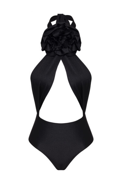 This is a stylish black halter-neck one-piece swimsuit with a unique design featuring a dramatic, voluminous ruffle at the chest, creating a floral or layered effect. The swimsuit has a cut-out detail under the ruffle, exposing part of the torso in a subtle yet elegant way. The material looks sleek and slightly glossy, enhancing the sophistication of the piece.