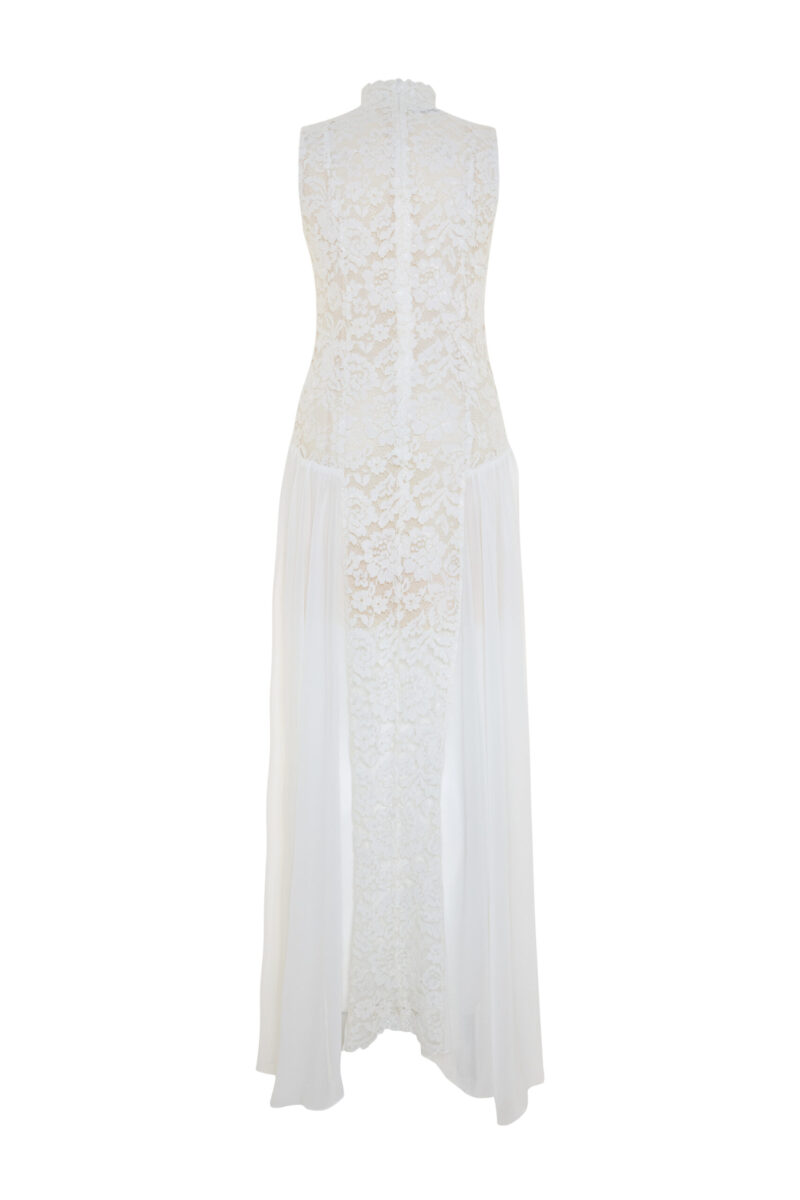 Elegant white Elaia dress crafted from Chantilly lace cord with high neckline, sleeveless silhouette, and flowing chiffon side panels – sophisticated bridal-inspired evening gown.