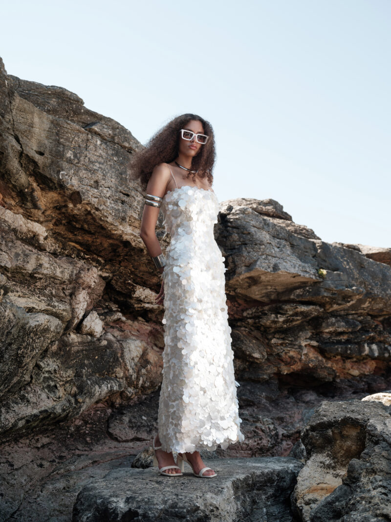Calista Ivory Mother-of-Pearl Sequin Maxi Dress by Nana Gotti featuring delicate spaghetti straps, oversized circular sequins, and an elegant fitted silhouette, front view.
