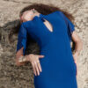 Close-up of the Nana Gotti Azura cobalt blue maxi dress highlighting its keyhole neckline, decorative tassel, sheer chiffon sleeves, and fitted satin bodice.
