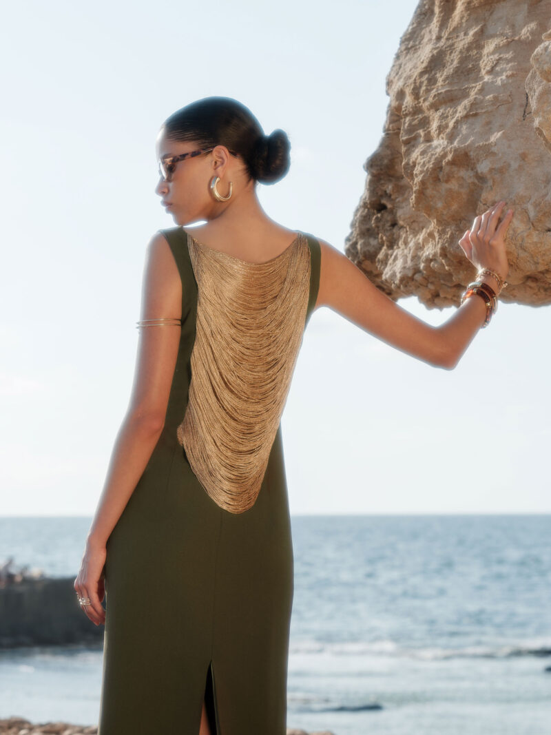 Close-up of Lara Crepe Chain-Drape Maxi Dress showcasing luxurious layered gold chains draped across the open-back design.