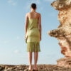 Back view of Nana Gotti Riva Olive Green Fringe Midi Dress featuring a fitted satin silhouette, concealed zipper, asymmetric draping, and cascading fringe hem.
