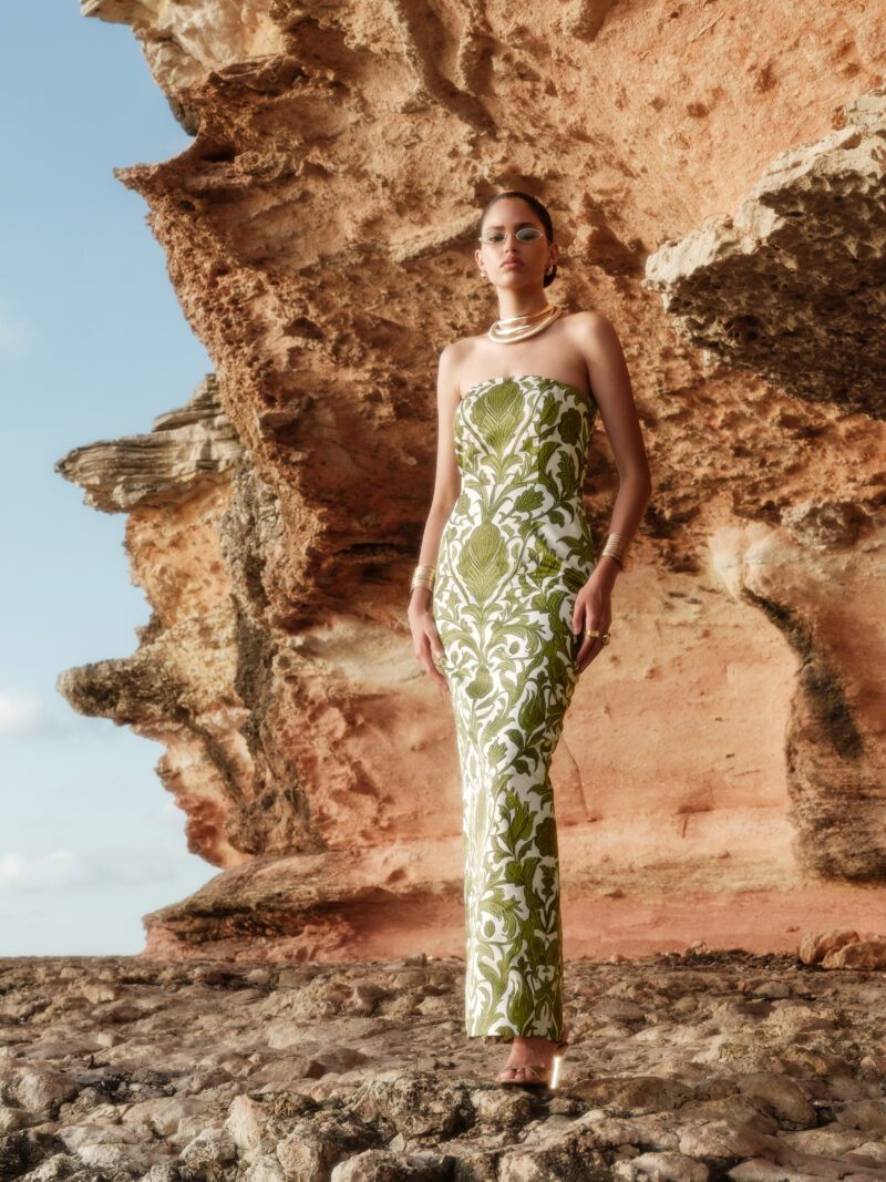 Model wearing Flora Strapless Floral Twill Satin Maxi Dress by Nana Gotti outdoors