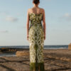 Back view of Aelia Strapless Maxi Dress featuring olive botanical print, ruffled neckline, and long fringe hem.
