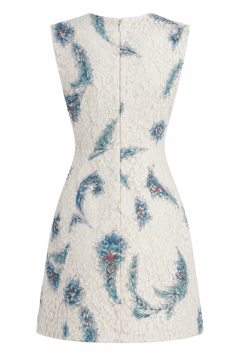 Back view of the Nana Gotti Narin ivory floral lace mini dress featuring blue botanical motifs, structured shoulders, and concealed back zipper.