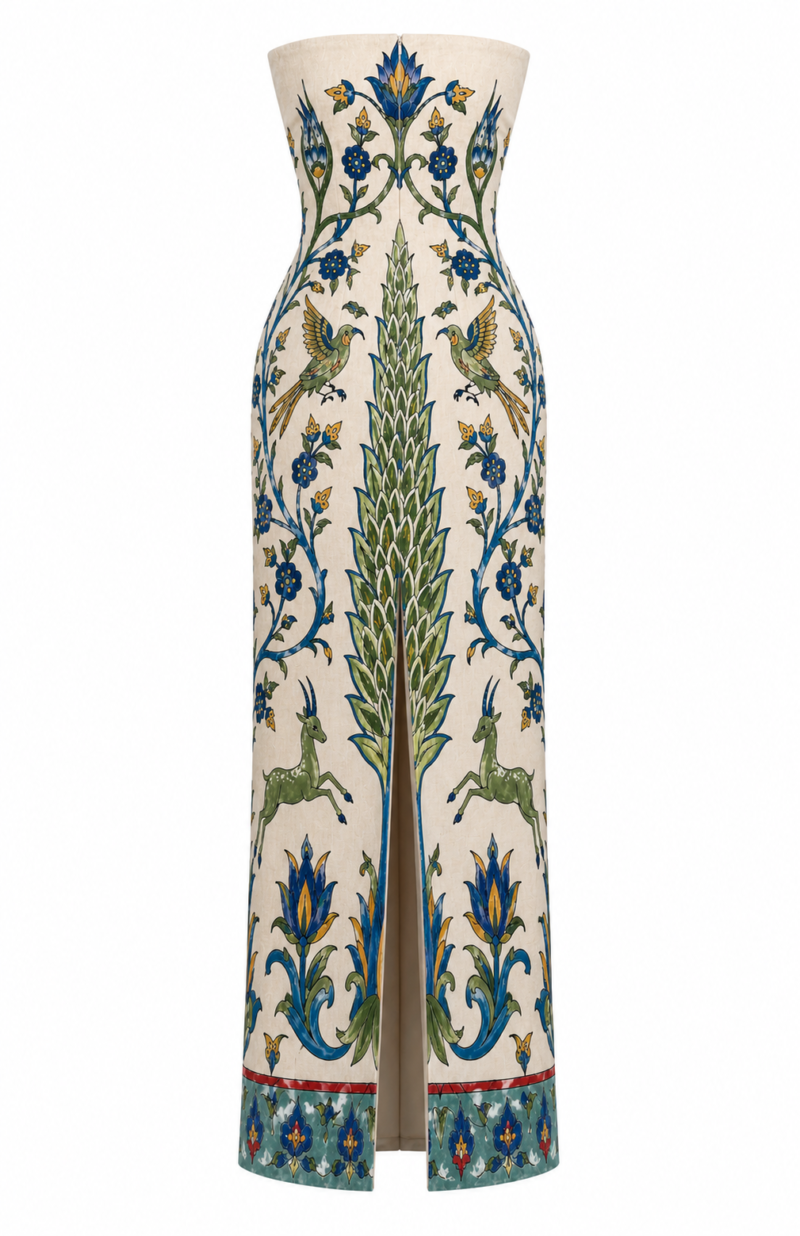 Back view of Nana Gotti Yara printed linen maxi dress featuring a fitted strapless silhouette, ornamental floral motifs and center-back slit.