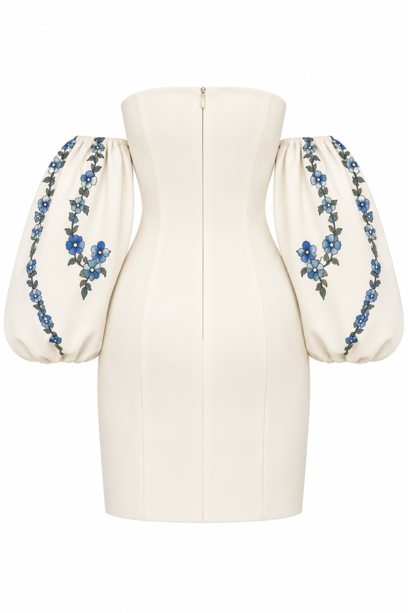Back view of Nana Gotti Lalezar ivory mini dress featuring a concealed zipper, fitted silhouette and voluminous blue floral balloon sleeves.