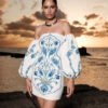 Nana Gotti Lalezar strapless floral mini dress in ivory and blue, styled with voluminous off-the-shoulder puff sleeves and sculpted crepe silhouette.